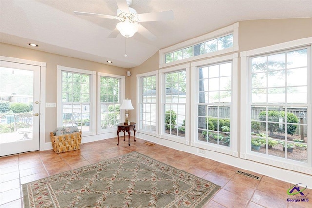sunroom / solarium with tile patterned floors, lofted ceiling, and recessed lighting