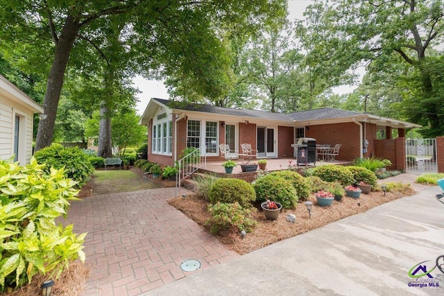 ranch-style home with brick siding and a patio area