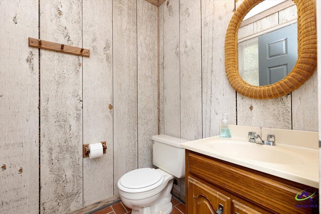 half bath featuring toilet and vanity