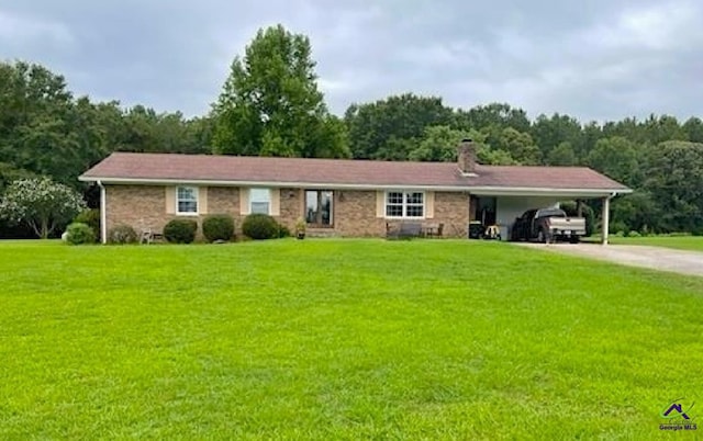 view of front of property featuring a front yard, concrete driveway, a carport, and a chimney