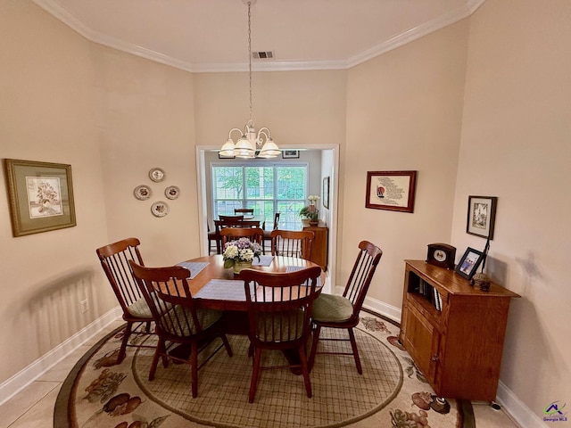 dining space with a chandelier, baseboards, and crown molding