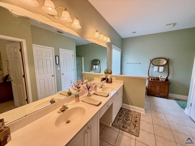 full bathroom with tile patterned flooring, double vanity, and baseboards