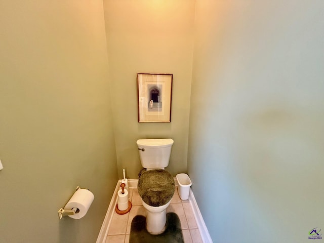 bathroom with tile patterned flooring, toilet, and baseboards