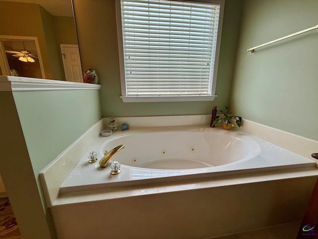 full bathroom with a tub with jets and plenty of natural light