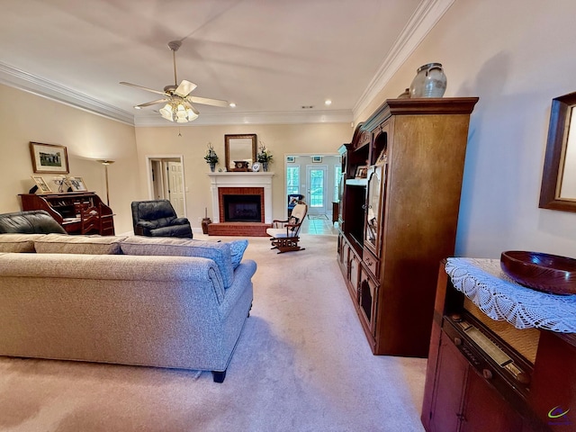 living area featuring light carpet, crown molding, a ceiling fan, a fireplace, and recessed lighting