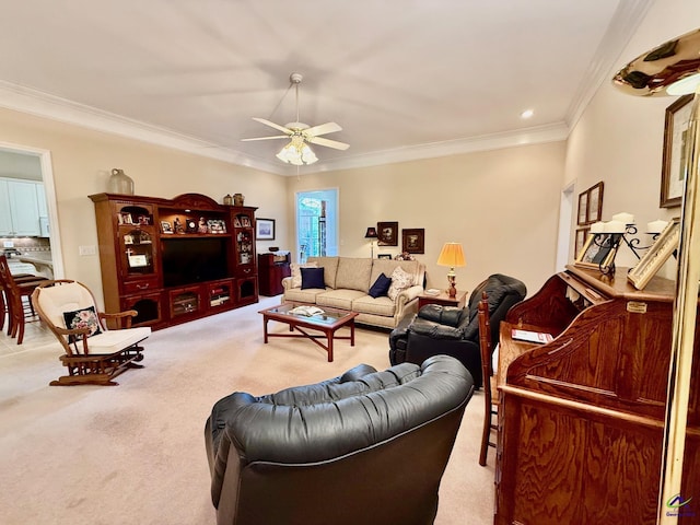carpeted living room featuring ornamental molding and ceiling fan