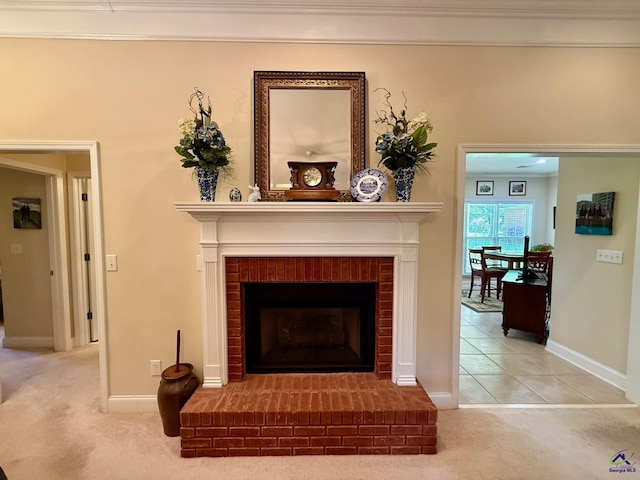 detailed view of a brick fireplace, carpet, and baseboards