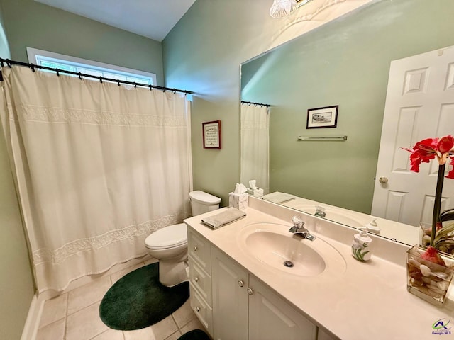 bathroom with tile patterned floors, toilet, vanity, and curtained shower