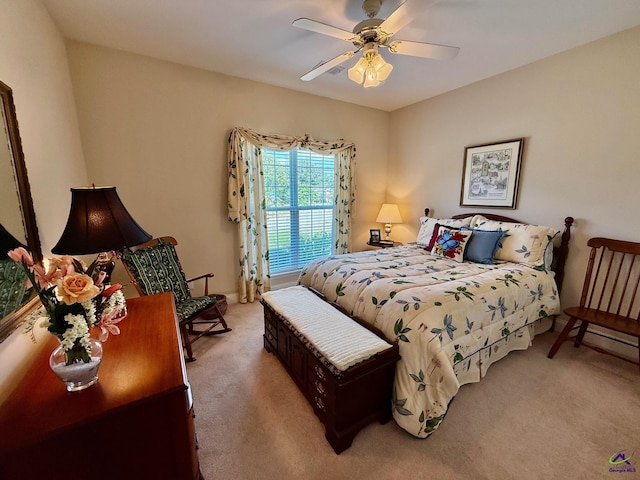 bedroom featuring light colored carpet and a ceiling fan