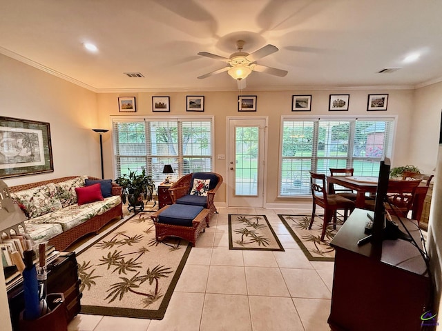 living room with light tile patterned floors, ceiling fan, healthy amount of natural light, and crown molding