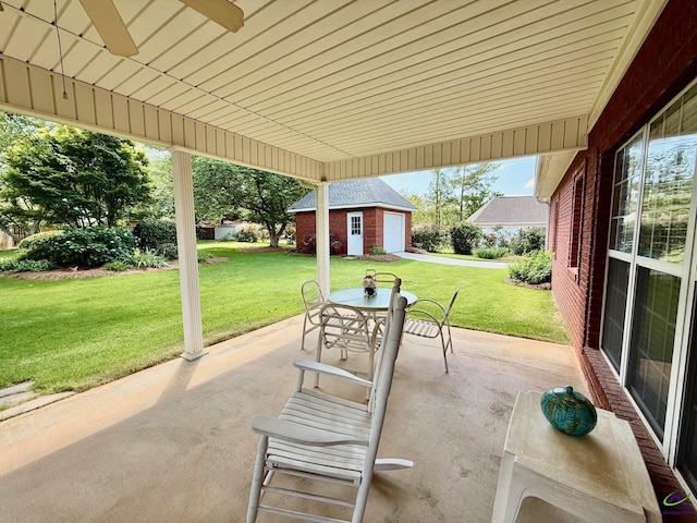 view of patio featuring an outbuilding, a ceiling fan, and outdoor dining space