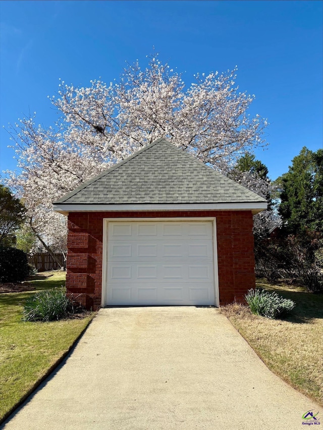 detached garage with concrete driveway