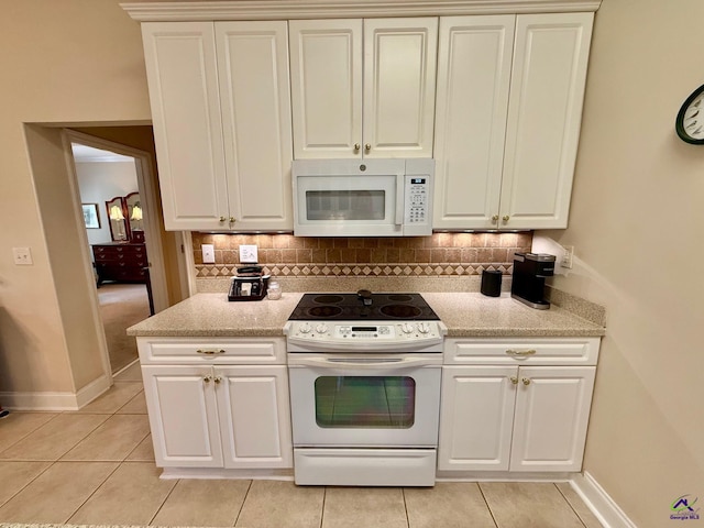 kitchen with white appliances, light tile patterned flooring, baseboards, and tasteful backsplash