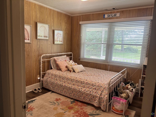174 Cabero Rd, Hawkinsville, GA 31036 - bedroom featuring wooden walls, ornamental molding, wood finished floors, and baseboards