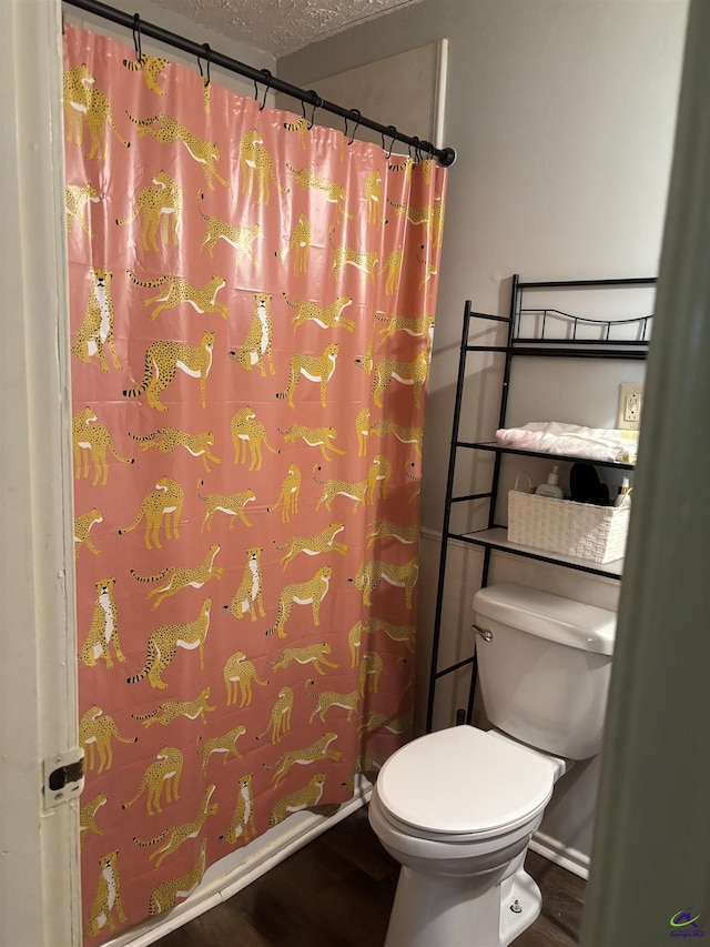 174 Cabero Rd, Hawkinsville, GA 31036 - bathroom with wood finished floors, toilet, a textured ceiling, and curtained shower