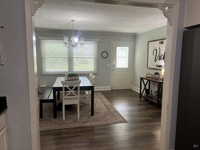 174 Cabero Rd, Hawkinsville, GA 31036 - dining room with ornamental molding, a chandelier, dark wood-style flooring, a textured ceiling, and baseboards