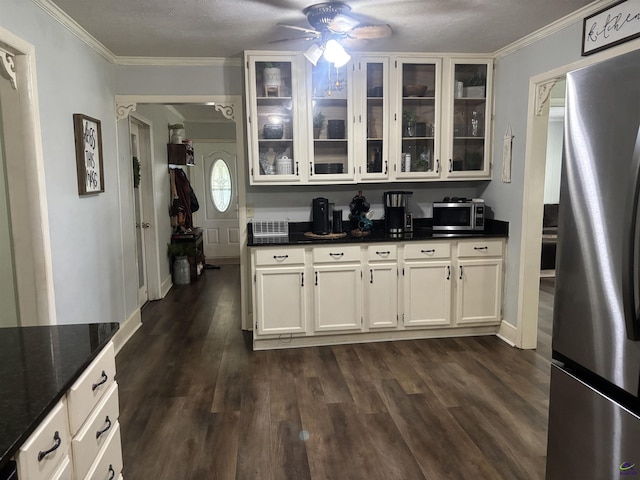 174 Cabero Rd, Hawkinsville, GA 31036 - kitchen with stainless steel appliances, ceiling fan, crown molding, dark wood-type flooring, and glass insert cabinets