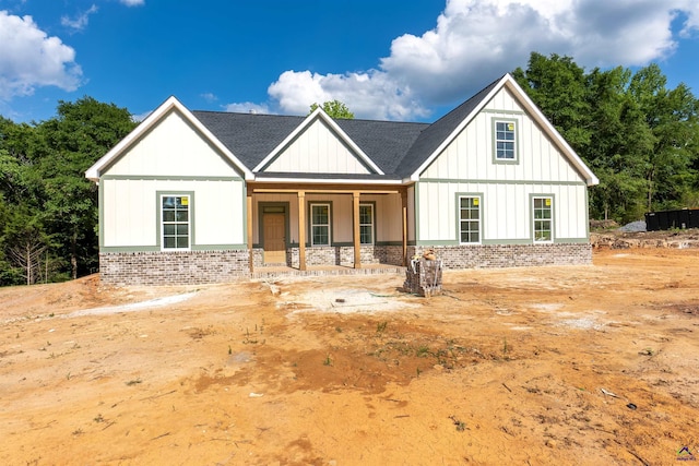 615 Head Rd, Juliette, GA 31046 - modern farmhouse style home featuring a porch, brick siding, board and batten siding, and a shingled roof