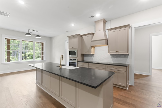 615 Head Rd, Juliette, GA 31046 - kitchen featuring custom exhaust hood, stainless steel appliances, dark countertops, decorative backsplash, and wood finished floors