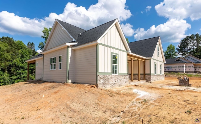 615 Head Rd, Juliette, GA 31046 - view of side of property featuring board and batten siding, brick siding, and roof with shingles