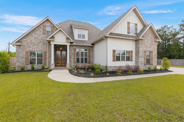 craftsman inspired home featuring french doors, board and batten siding, roof with shingles, and brick siding