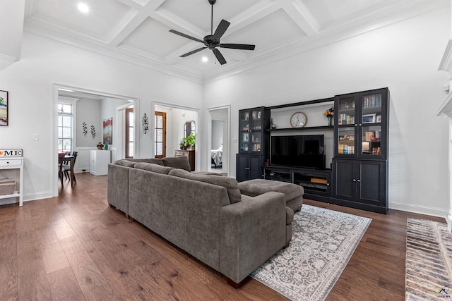 living room featuring a ceiling fan, dark wood-style floors, coffered ceiling, a towering ceiling, and beamed ceiling