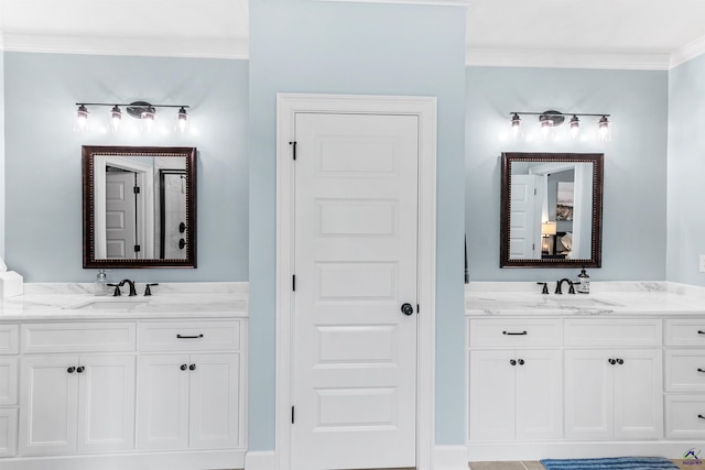 bathroom with crown molding and two vanities