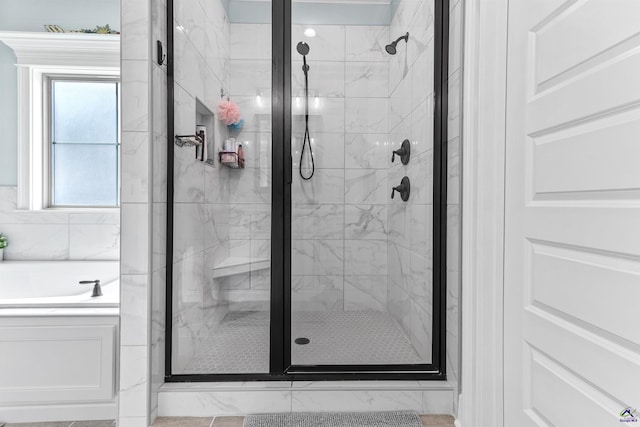 full bath featuring a stall shower and a bath
