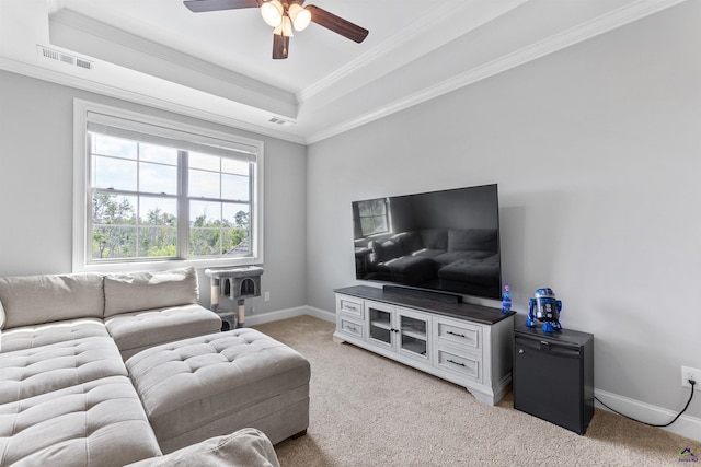 living room featuring ceiling fan, light carpet, crown molding, a raised ceiling, and baseboards