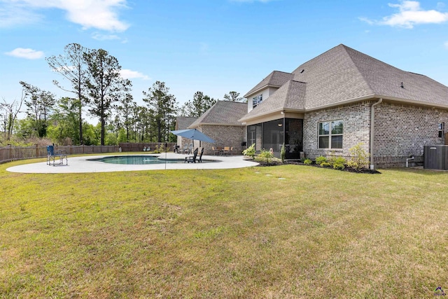 view of yard with a patio, central air condition unit, and a sunroom