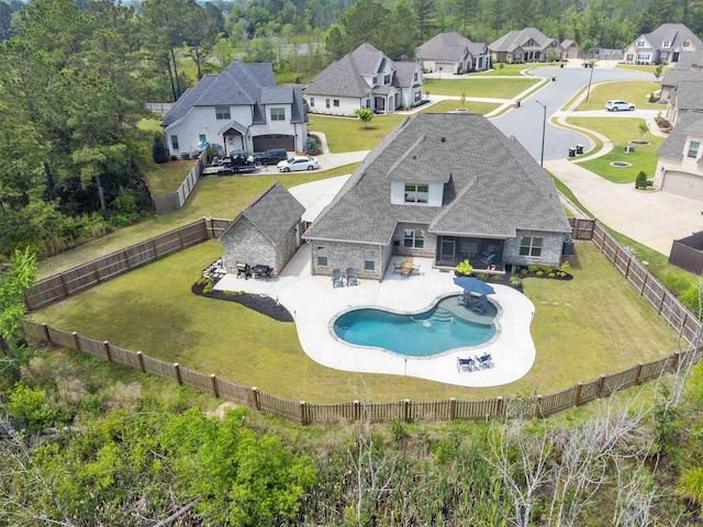 rear view of house featuring stone siding and a residential view