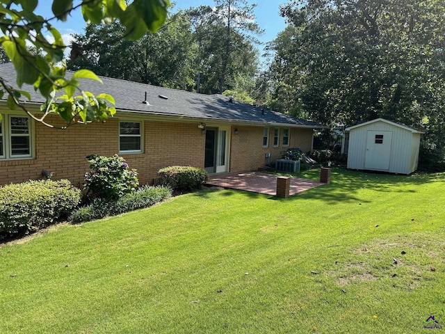 back of property featuring a patio area, brick siding, central AC unit, and a lawn