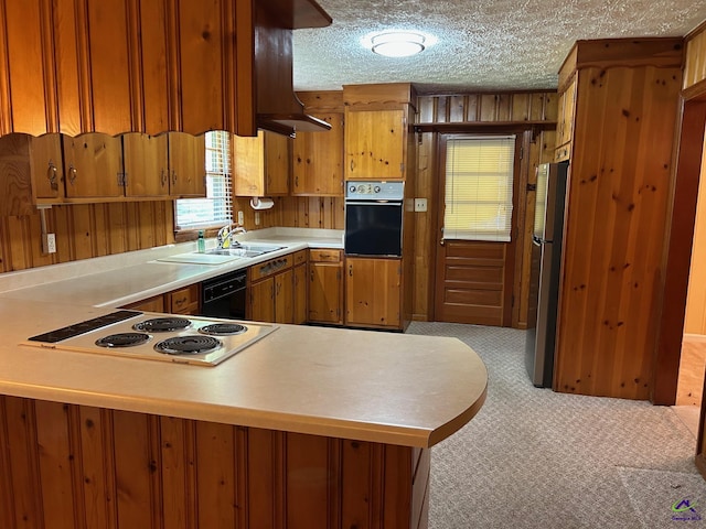 kitchen with oven, freestanding refrigerator, light countertops, extractor fan, and cooktop