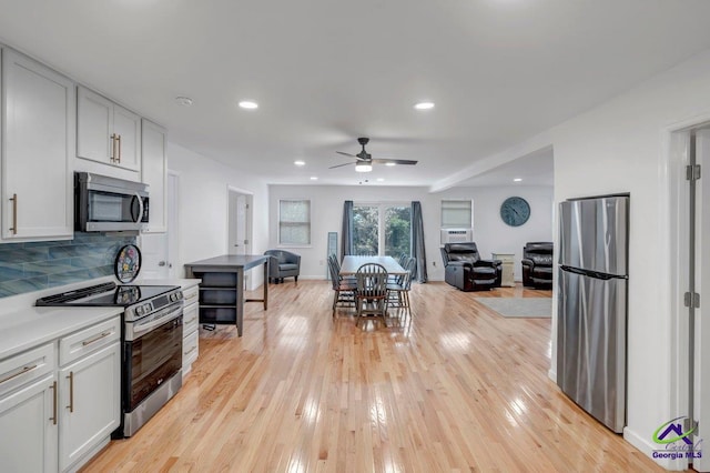 257 Macon Rd, Reynolds, GA 31076 - kitchen with appliances with stainless steel finishes, open floor plan, a ceiling fan, light wood-style flooring, and recessed lighting