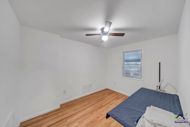 257 Macon Rd, Reynolds, GA 31076 - unfurnished bedroom with light wood finished floors, baseboards, and ceiling fan