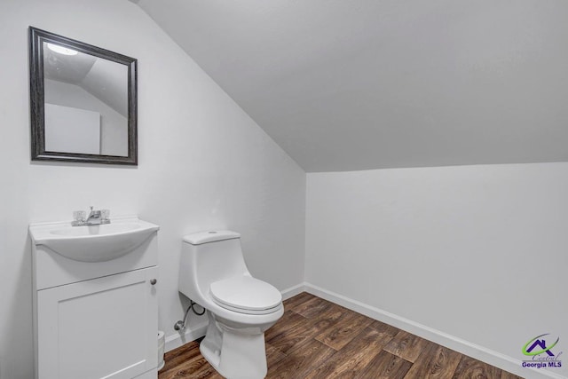 257 Macon Rd, Reynolds, GA 31076 - bathroom with vaulted ceiling, wood finished floors, vanity, baseboards, and toilet