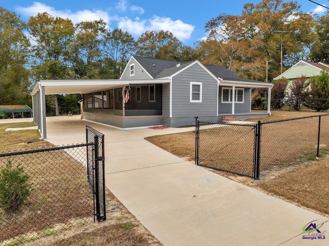 257 Macon Rd, Reynolds, GA 31076 - view of front of house with a gate, an attached carport, and a fenced front yard