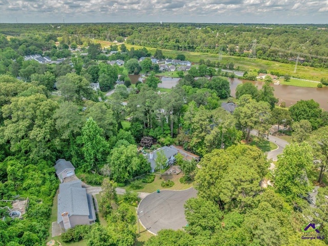 aerial view of property and surrounding area featuring a forest