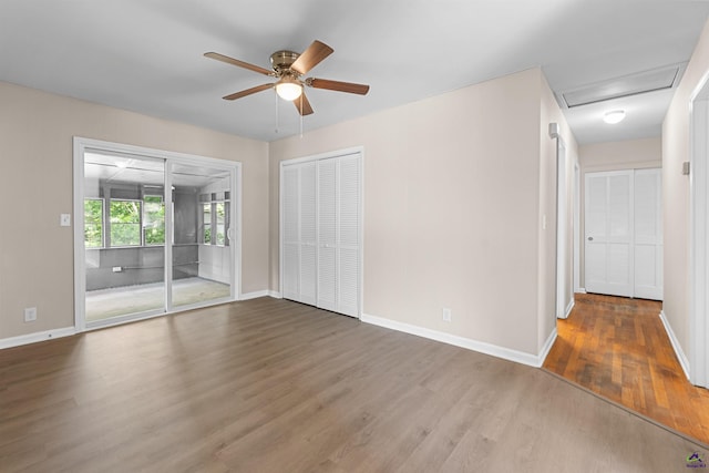 unfurnished room with ceiling fan, wood finished floors, and baseboards