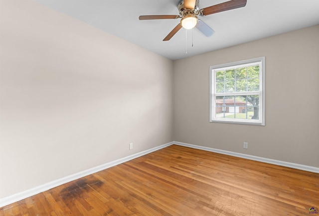 unfurnished room with baseboards, light wood-style flooring, and a ceiling fan