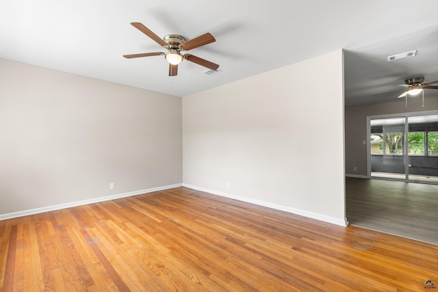 spare room featuring ceiling fan, wood finished floors, and baseboards