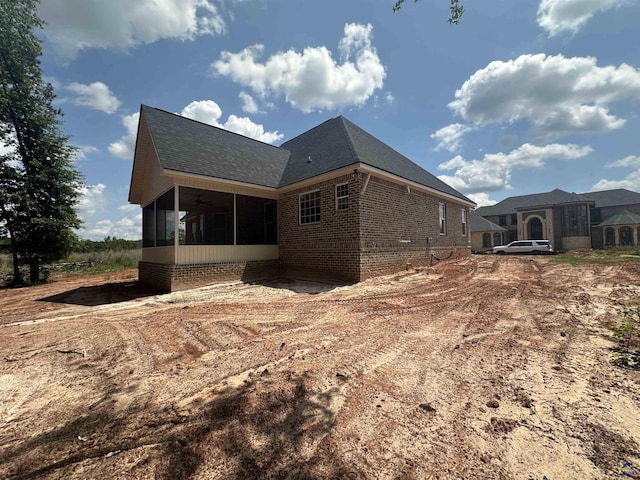 405 Buckhead Forest Dr, Warner Robins, GA 31088 - back of house with a sunroom, brick siding, and roof with shingles