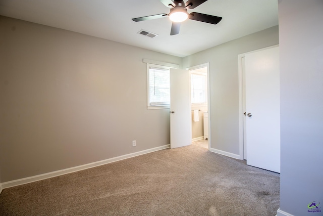 unfurnished bedroom featuring carpet, baseboards, connected bathroom, and a ceiling fan