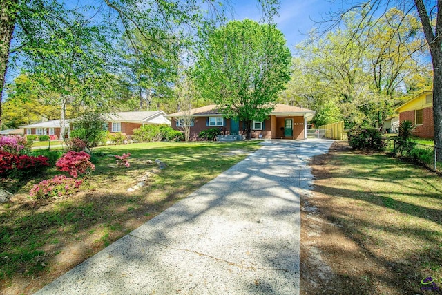 ranch-style house featuring concrete driveway
