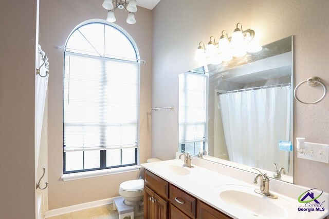 209 Ridgestone, Warner Robins, GA 31088 - bathroom with double vanity, toilet, a chandelier, and curtained shower