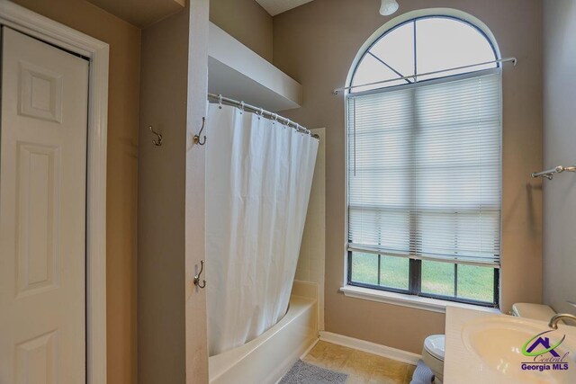 209 Ridgestone, Warner Robins, GA 31088 - bathroom with baseboards, toilet, tile patterned floors, shower / bath combo with shower curtain, and a sink