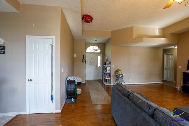 209 Ridgestone, Warner Robins, GA 31088 - living room with wood finished floors, baseboards, ceiling fan, and a textured ceiling