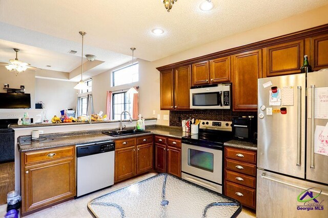209 Ridgestone, Warner Robins, GA 31088 - kitchen with stainless steel appliances, a sink, a peninsula, open floor plan, and dark countertops