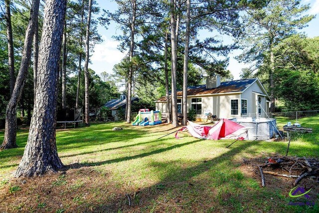 209 Ridgestone, Warner Robins, GA 31088 - view of yard with a trampoline and a playground
