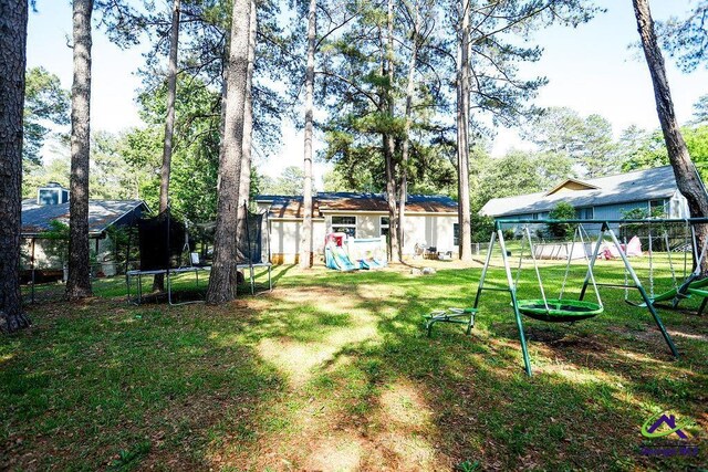 209 Ridgestone, Warner Robins, GA 31088 - view of grassy yard with a trampoline and a playground